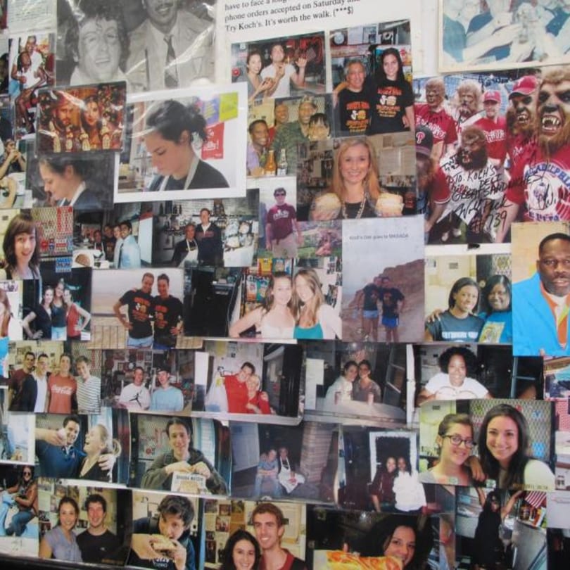 A collage of customer and staff photos covers a wall at Koch's Deli.